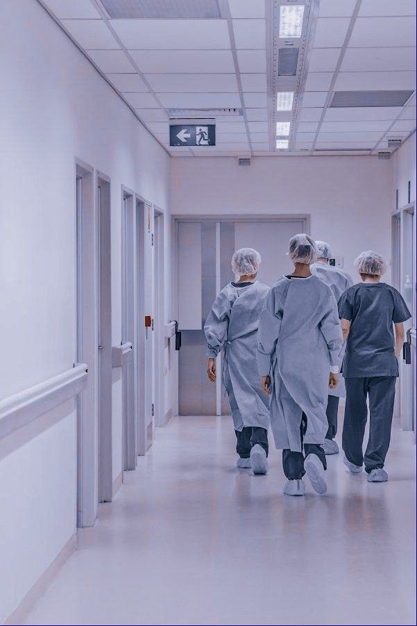Clinical staff walking together through a hospital corridor